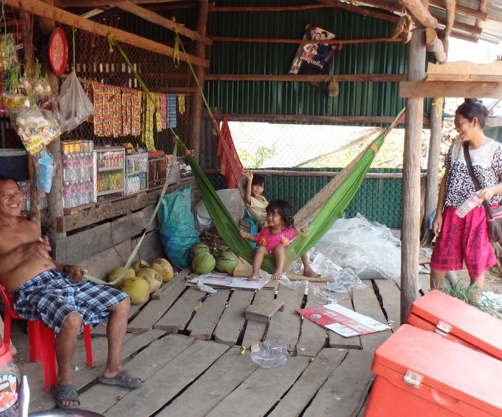 The family from the other side of the road showing how to rock a little girl with a hammock